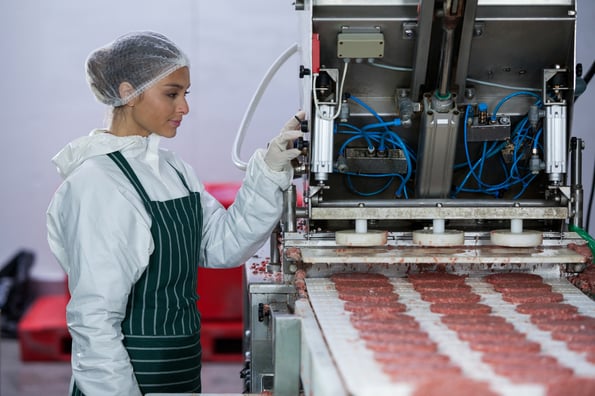 female-butcher-processing-hamburger-patty-2023-11-27-05-14-01-utc-1