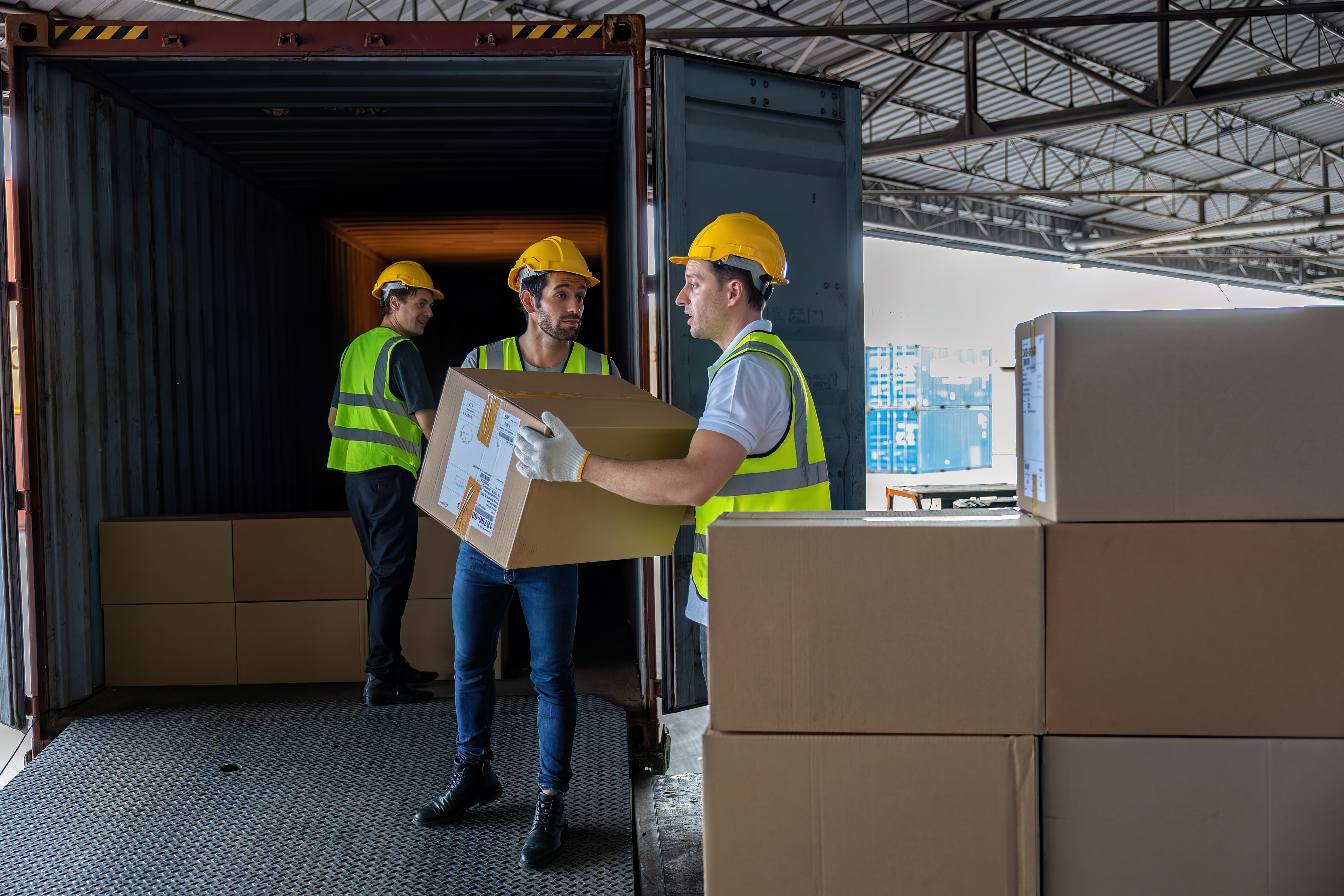 3-workers-hand-carry-carton-box-take-from-40-feet-2024-10-18-04-35-54-utc