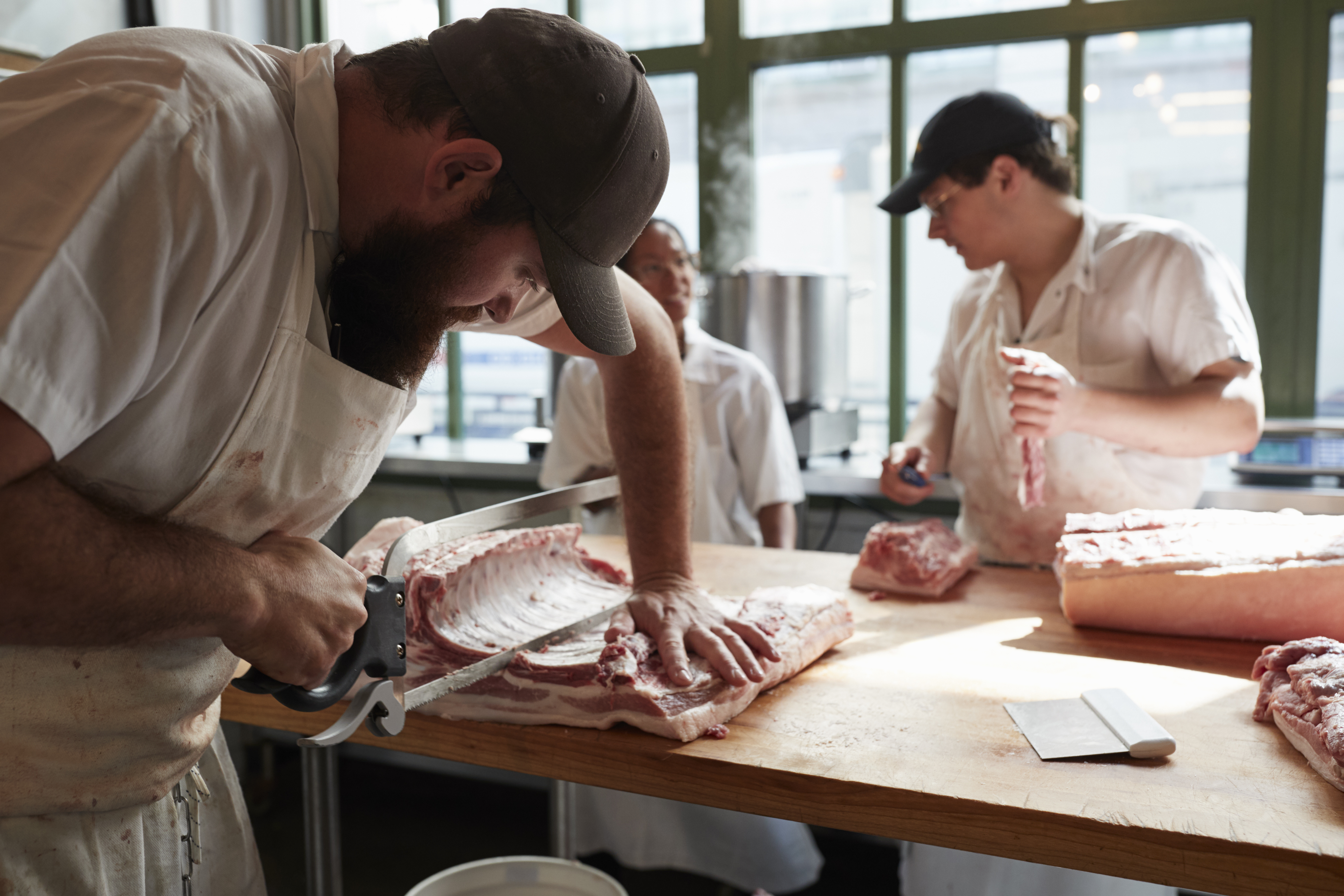 three-butchers-preparing-meat-cuts-of-meat-in-butc-2024-10-19-13-29-19-utc-1